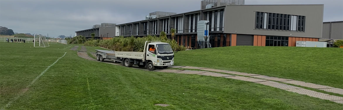 Truck driving on ground protection mats